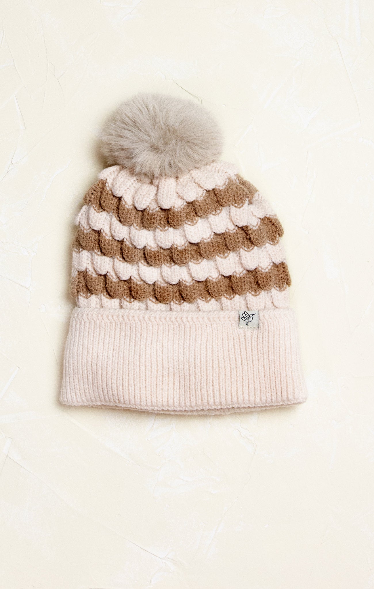 Ella Winter Lodge Beanie, brown and ivory stripe detail, cuffed rim, pom pom, flat lay