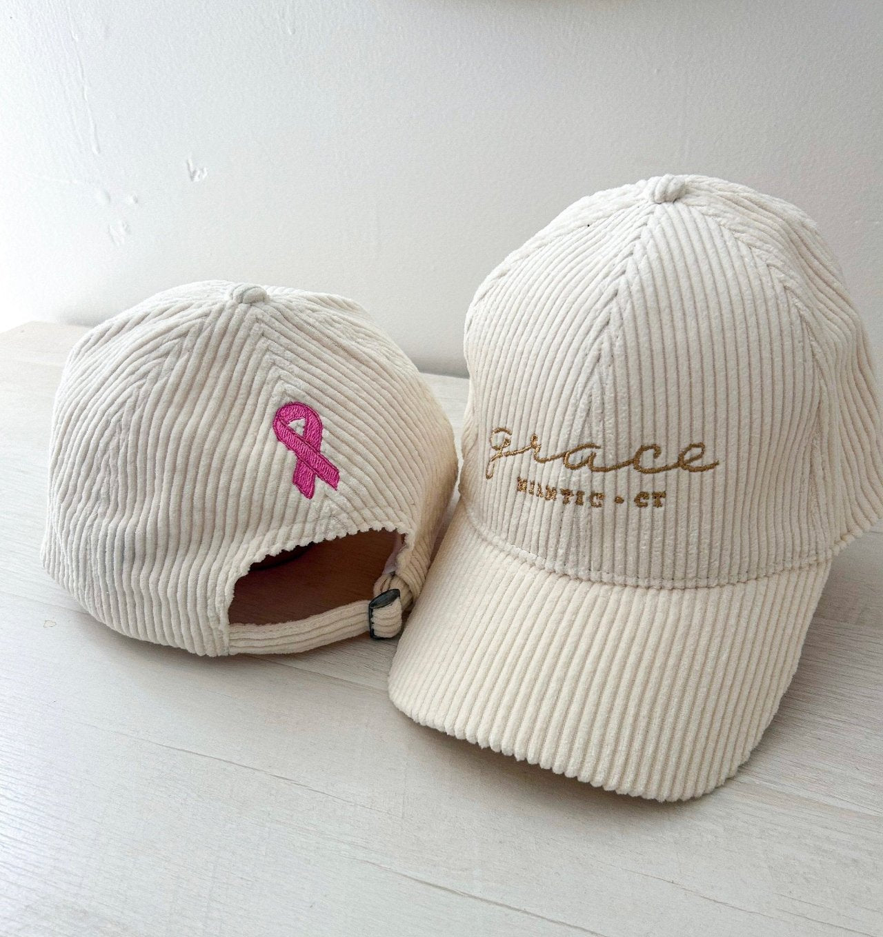 Grace Breast cancer Awareness Caps, front and back, grace branding on front, breast cancer symbol on back 